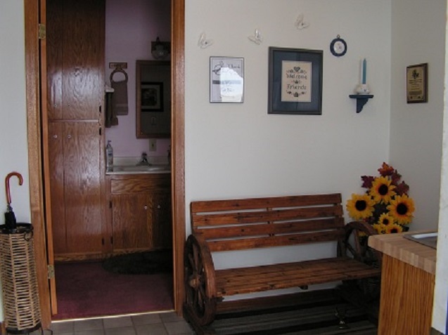 The back entry with a sink and coat closet.